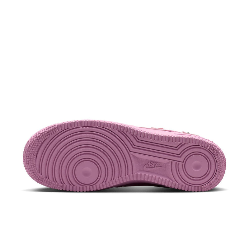 Pink rubber outsole of low-top sneakers with circular traction pattern