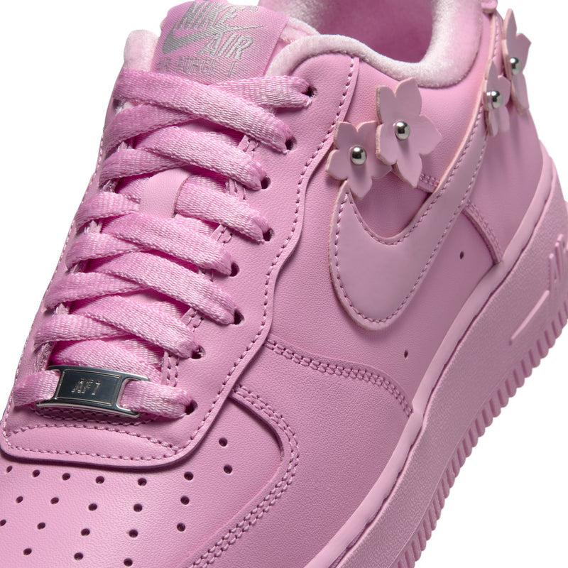 Pink leather low-top sneaker upper with lace-up, Swoosh, and flower studs