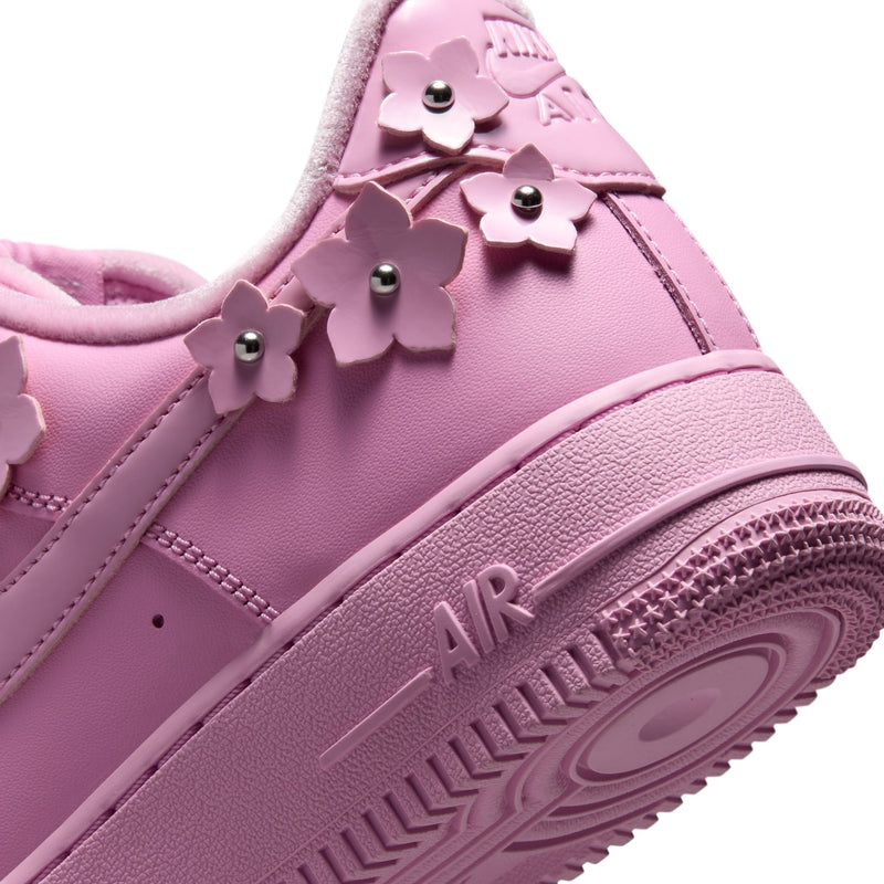 Pink sneaker heel with flower appliques and AIR text on the outsole