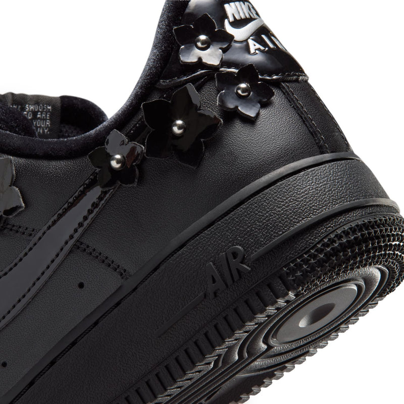 Women's black low-top sneaker close-up of AIR text and textured midsole