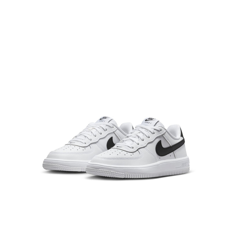 Kids' white low-top sneakers with black swoosh, lace-up, side view of pair