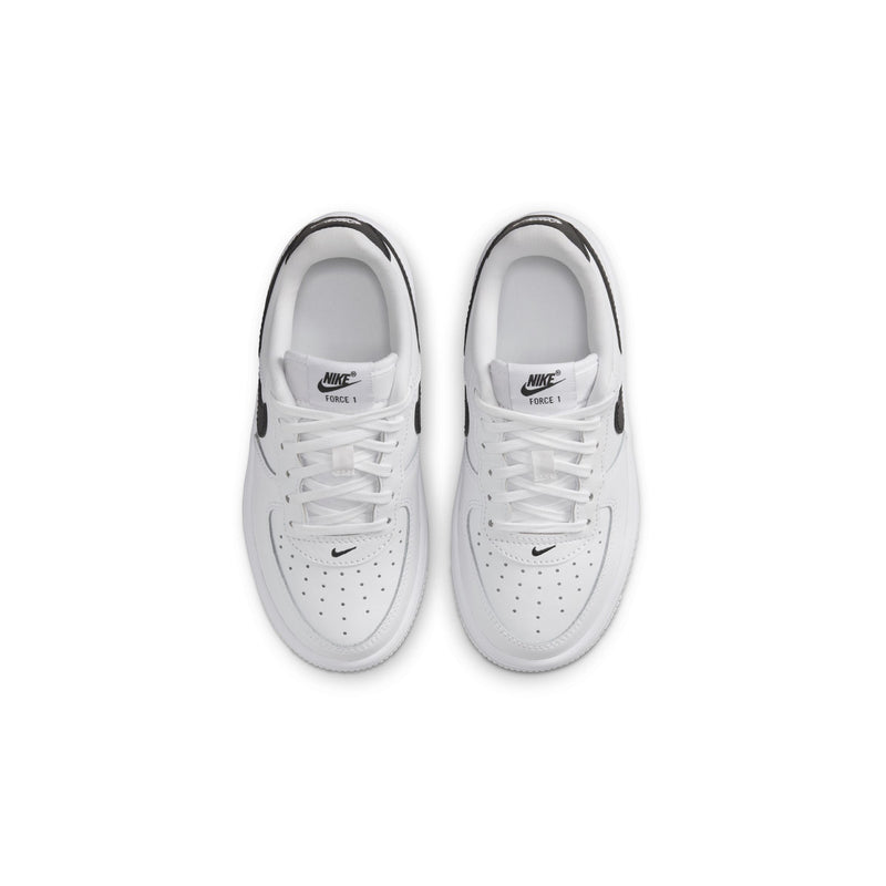 Kids' white sneakers with perforated toe and laces, top view of pair