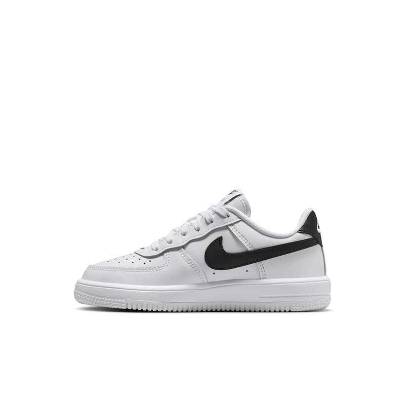 Kids' white sneakers with black swoosh stripe detail, side view