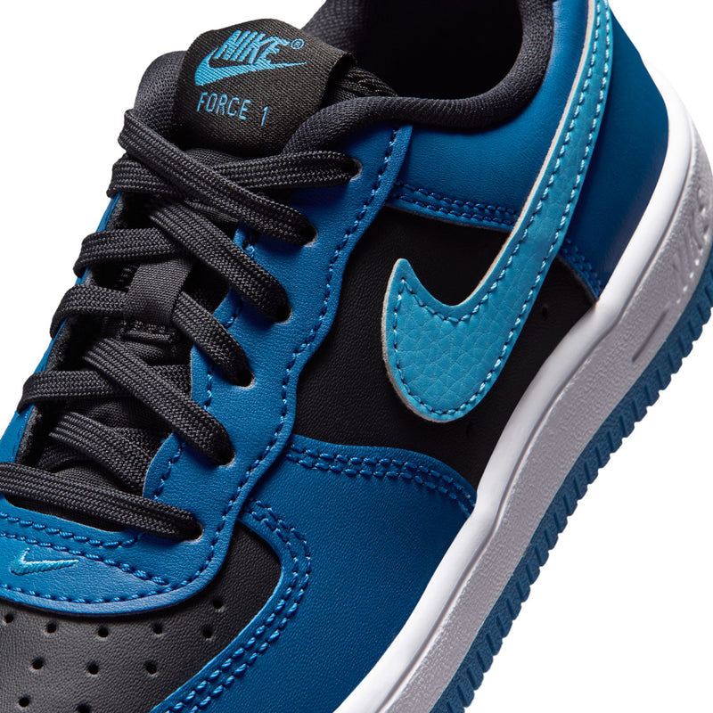 Kids Nike Air Force 1 sneakers close-up, black laces with blue swoosh and stitched panels