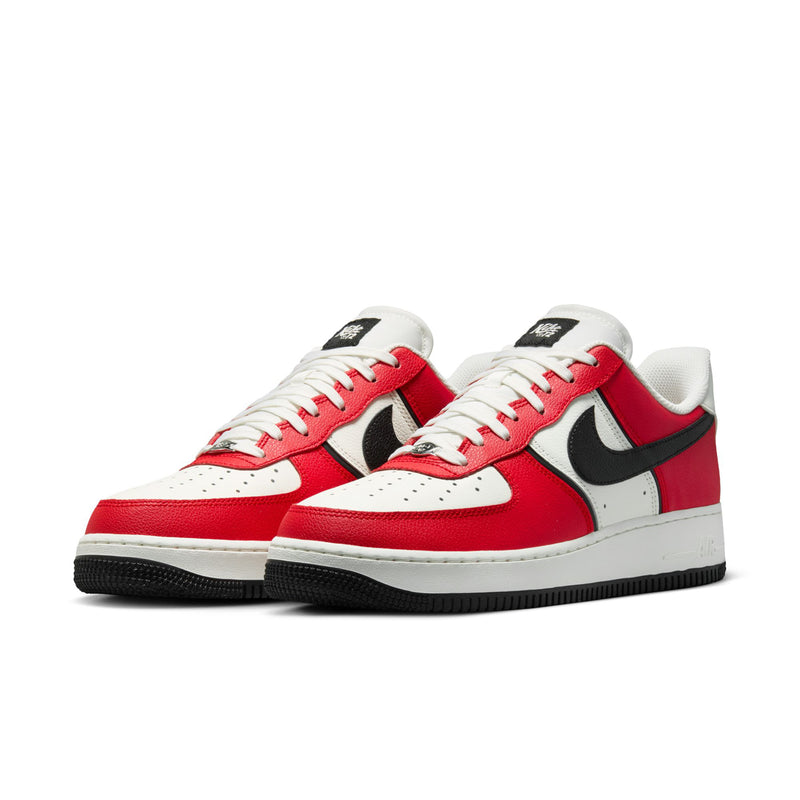 Pair of men's low-top sneakers with red uppers, black swoosh, and white rubber sole
