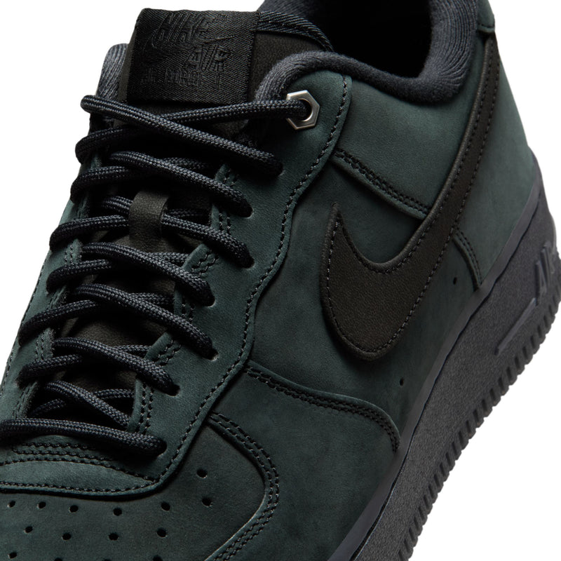 Men's Nike Air Force 1 Low sneakers, close-up of dark green suede lace-up upper