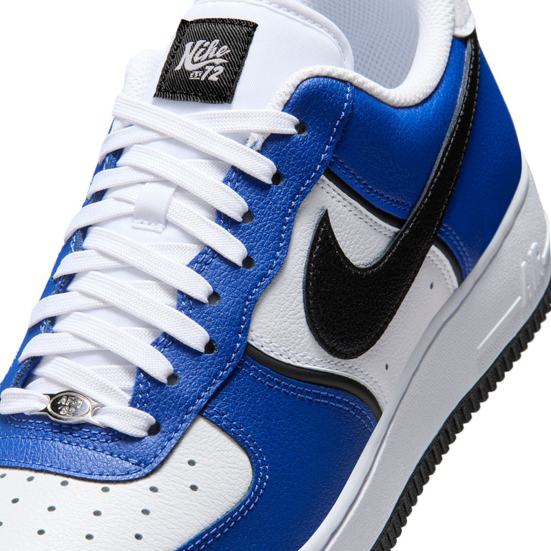 Nike Air Force 1 Low men's sneakers with white laces and blue leather panels.