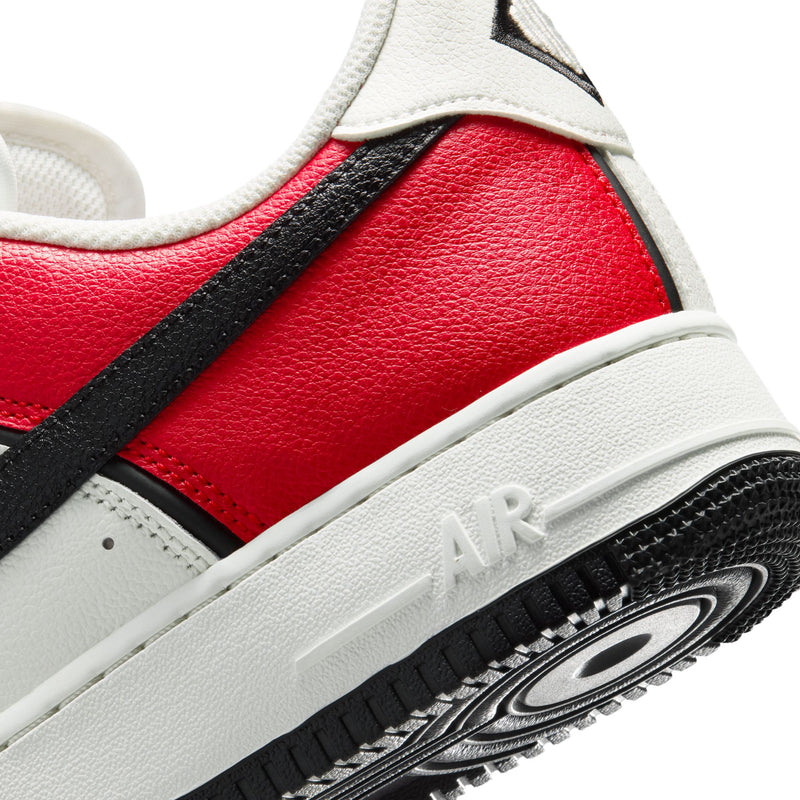 Close-up of men's midsole with Air branding, red and black panels, and textured outsole