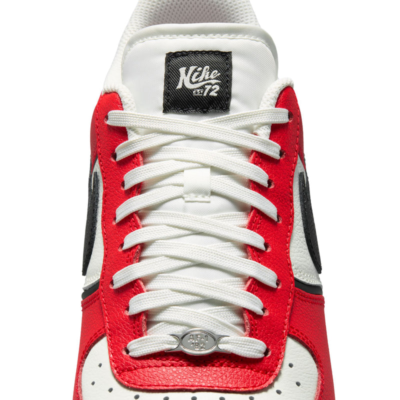 Top view of men's low-top sneaker with white laces, red toe panel, and black side swoosh