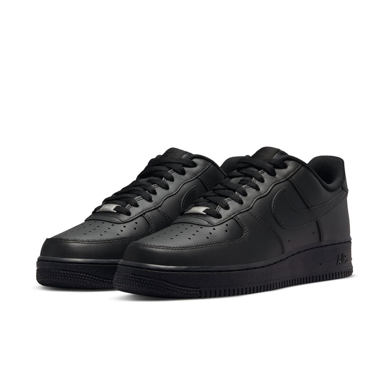 Black low-top lace-up sneakers with perforated toe and visible side swoosh