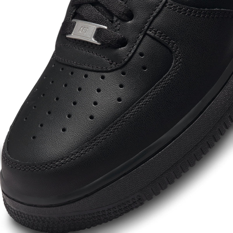 Black sneaker toe with perforations and lace eyelets; small side logo tag