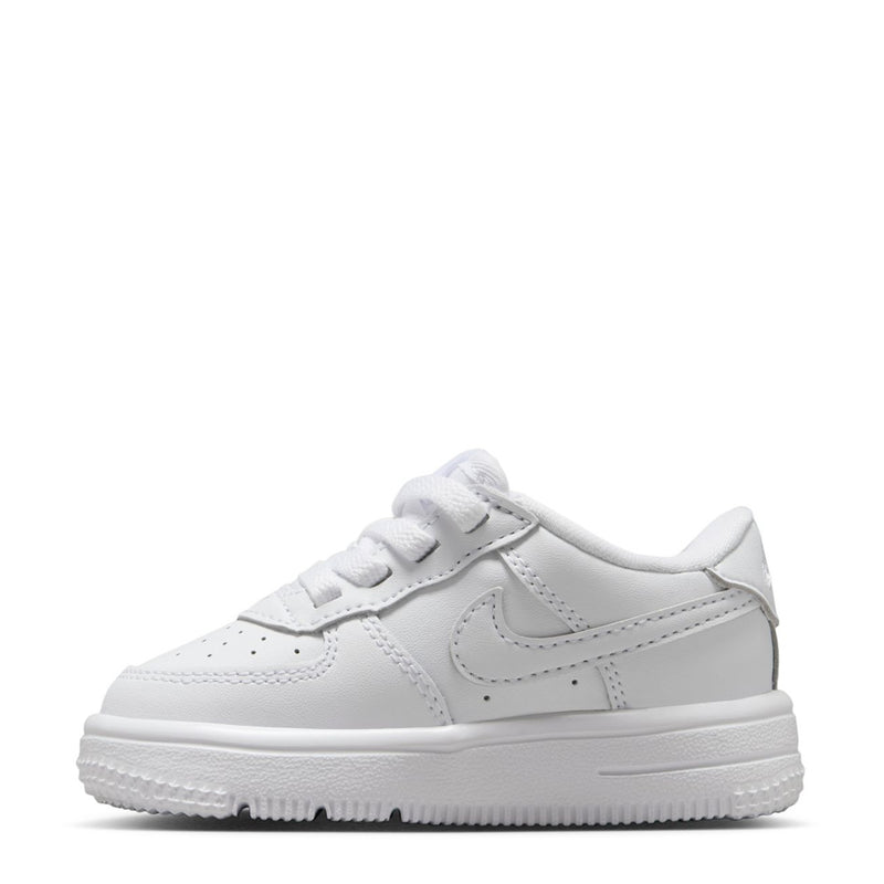 White toddler low-top sneakers, front-side view, lace-up and stitched swoosh