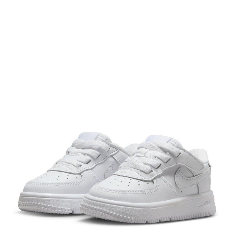Pair of white toddler low-top sneakers with lace-up design and textured sole
