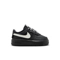 Black toddler low-top sneaker with white swoosh and black rubber sole