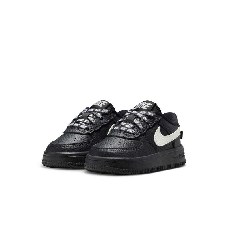 Pair of black toddler low-top sneakers with white swoosh detail