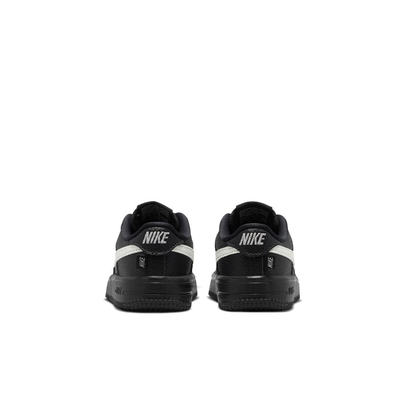 Black toddler low-top sneakers with rear Nike logo and padded heel