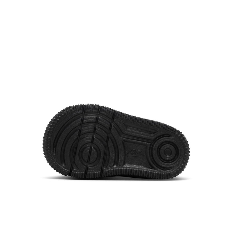 Black toddler sneaker outsole with tread pattern and circular traction zones