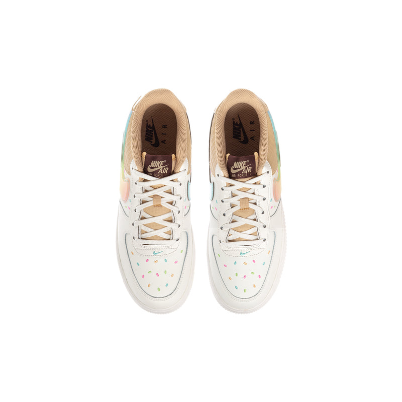 Pair of youth low-top sneakers with white laces, tan collars, and multicolor speckled details