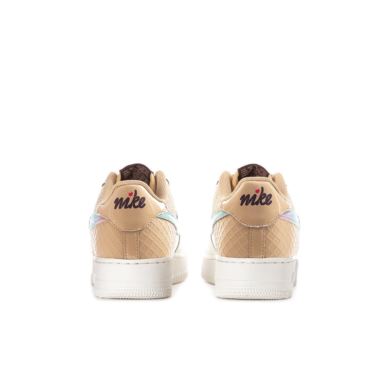 Youth low-top sneakers heel view with tan back tabs and Nike branding, white outsole