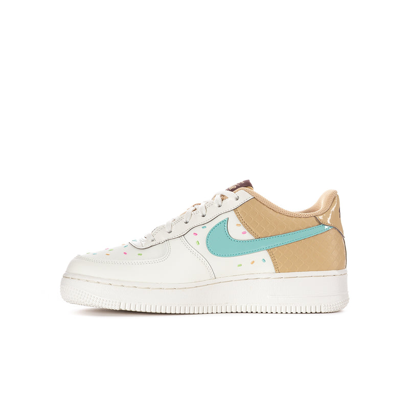 Youth low-top sneakers side view: white leather with tan overlays and teal swoosh