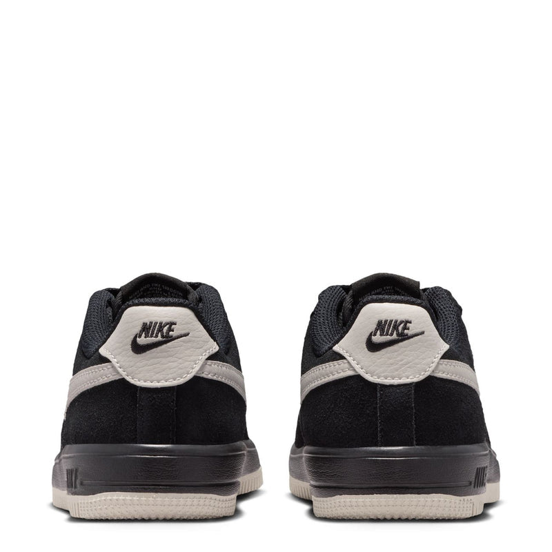 Kids black sneakers rear view with Nike heel tab and light bone accents