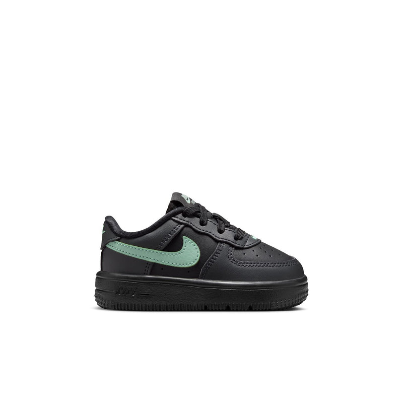 Toddler low-top Nike sneaker in black with mint green swoosh and lace-up styling