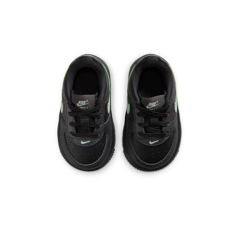 Toddler Nike sneaker view from above, black uppers with mint green logo details