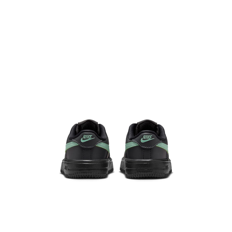 Toddler Nike sneaker back view, black heel with mint green stripe and lace tabs