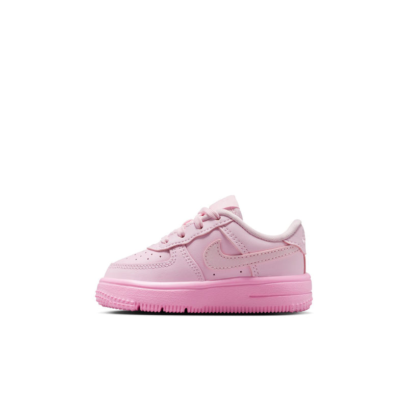 Pink toddler low-top sneaker with lace-up front and swoosh detail on the side