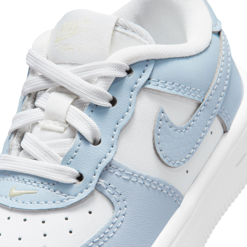 Toddler Nike Air Force 1 sneaker upper close-up, light blue swoosh and white laces