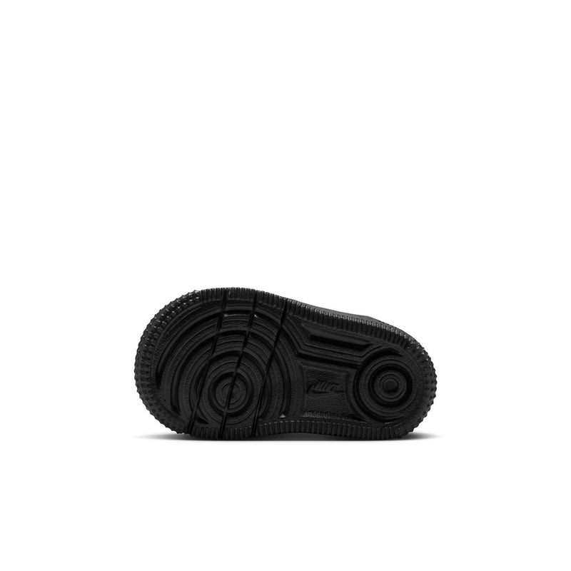 Toddler Nike sneaker outsole view, dark rubber traction tread on the bottom