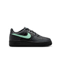 Black youth Air Force 1 low-top sneakers with mint green Swoosh and laces.