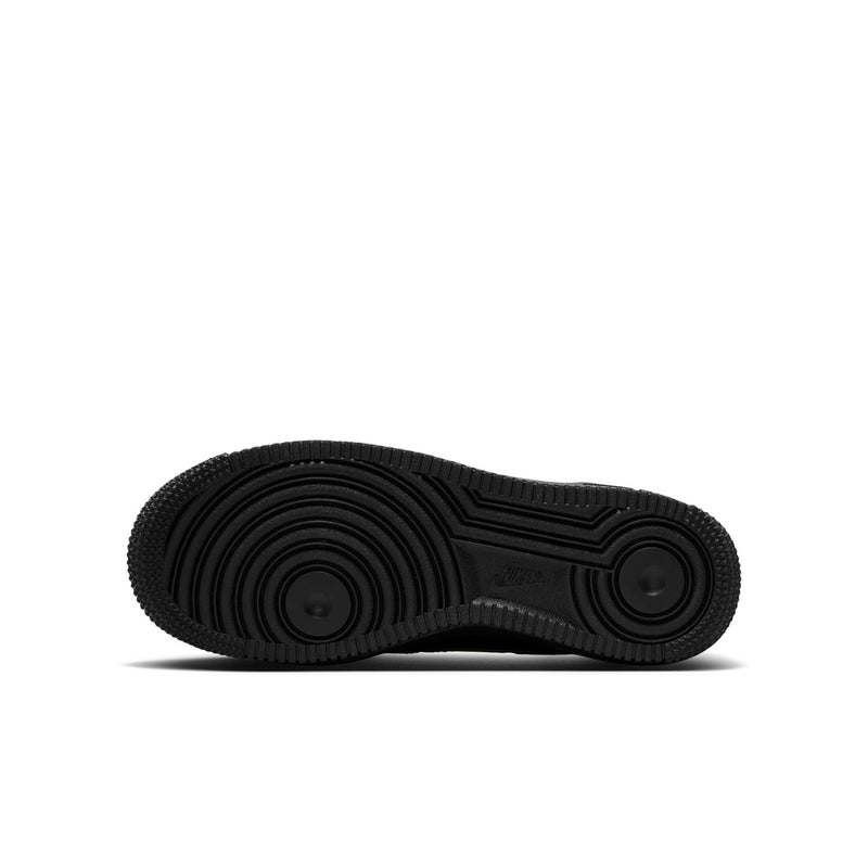 Black rubber outsole for youth sneakers with circular traction pattern.