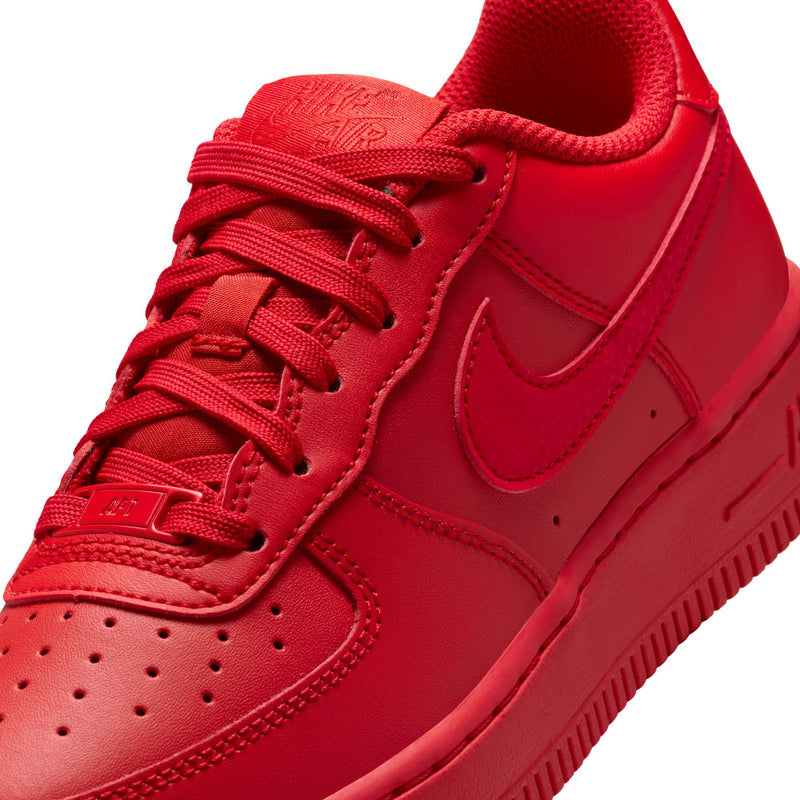 Close-up of red youth sneaker with lace-up front and Nike swoosh