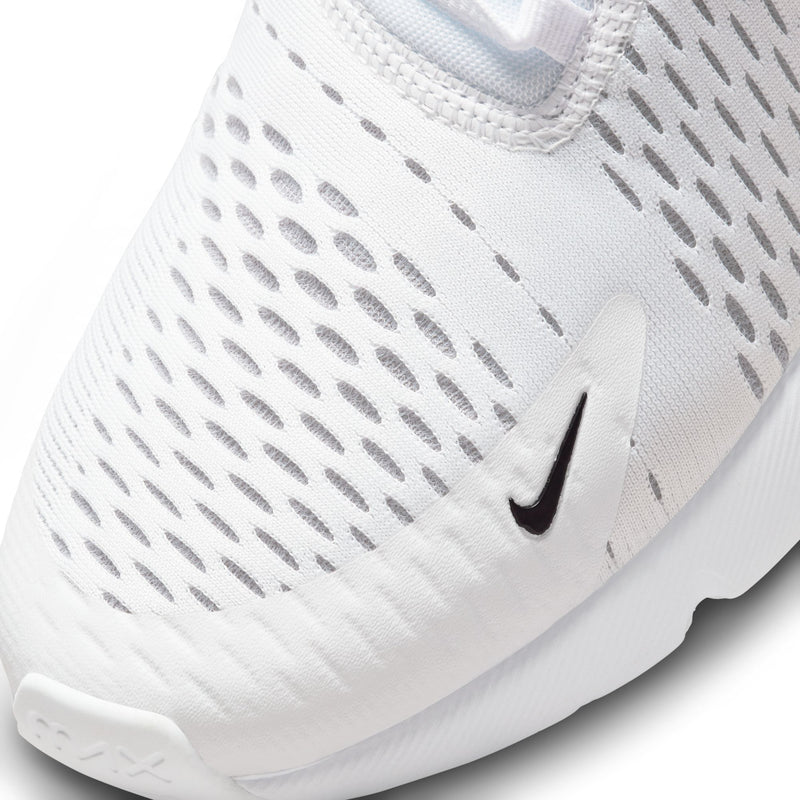 Close-up of white mesh upper with perforated pattern and black Nike swoosh