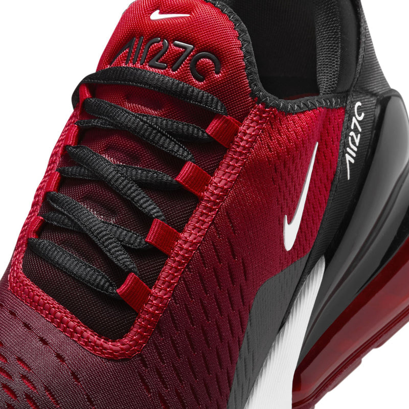 Close-up of men's Nike Air sneaker, red laces and knit upper with black heel logo.