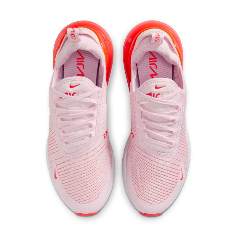 Pair of light pink sneakers with lace-up front and red-tinted Air sole