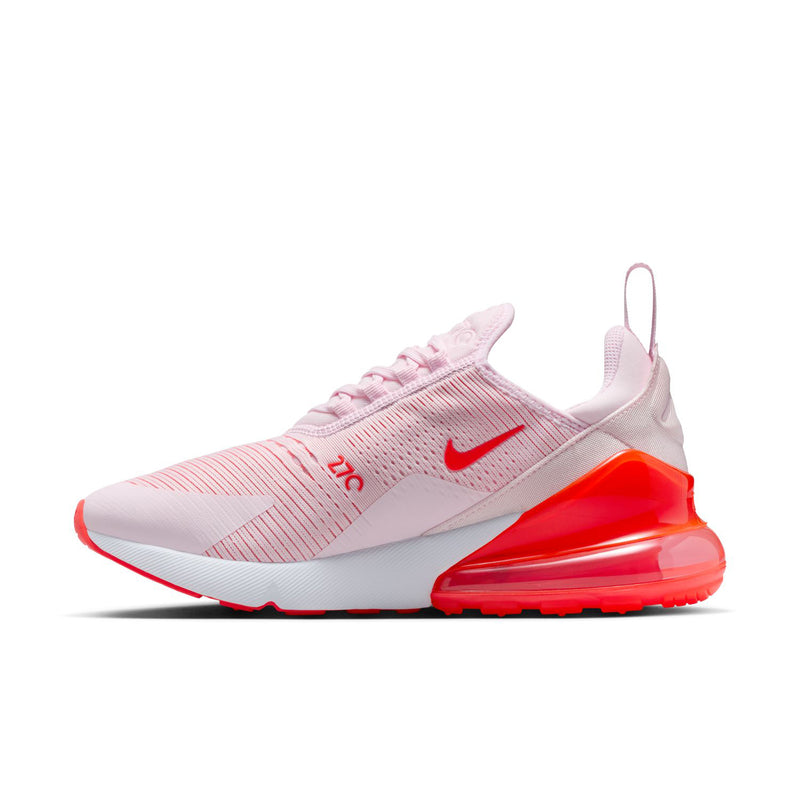 Women's light pink running shoe with red Air window and Nike swoosh on side