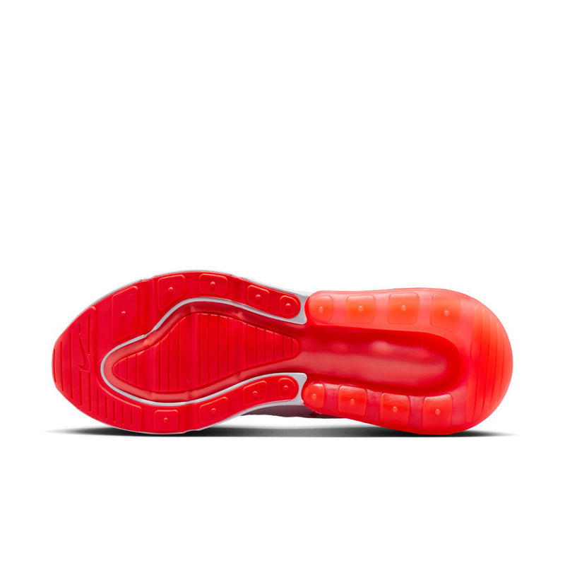 Red traction outsole of a light pink running shoe with Air unit at heel