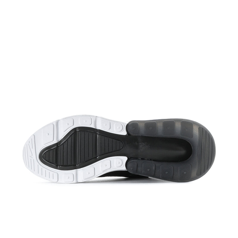 Women’s sneaker outsole bottom view with traction tread and white-and-dark rubber