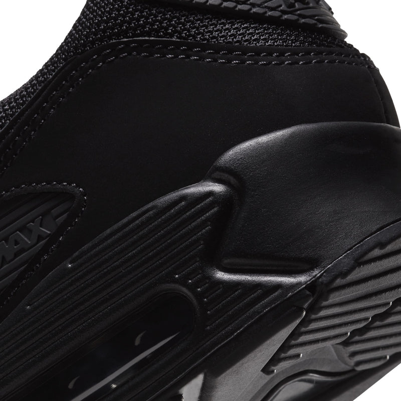 Close-up of black Nike sneaker midsole and outsole with sculpted grooves and Air unit window