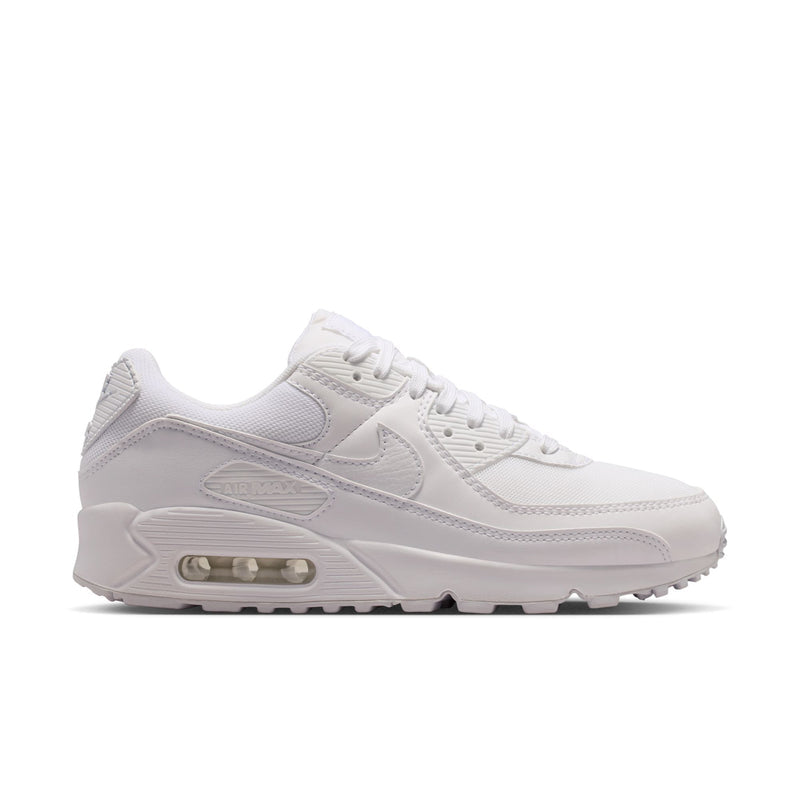 Women's white running sneakers with visible Air cushioning and lace-up front