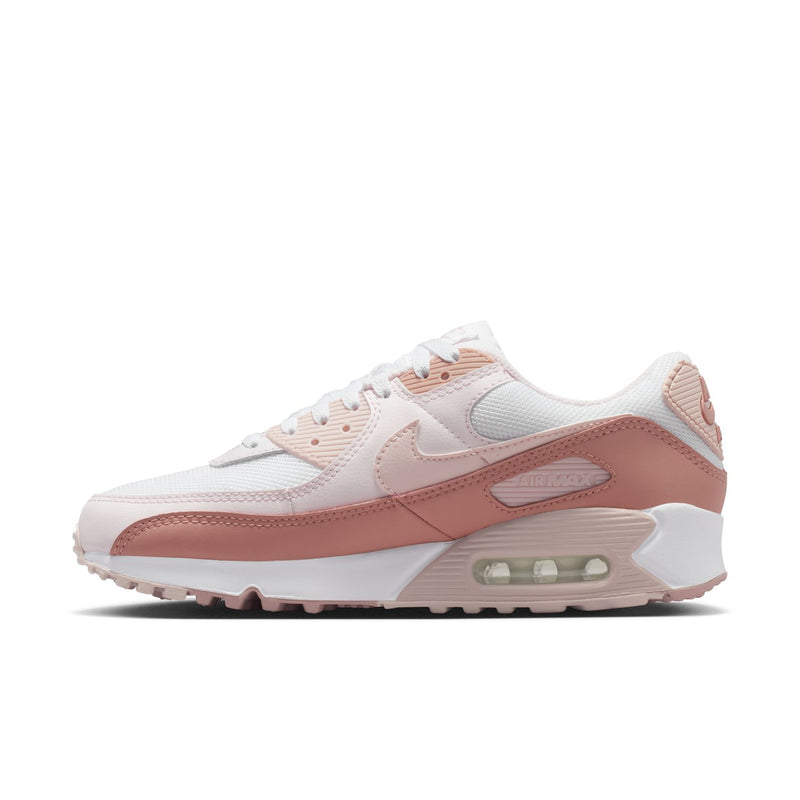Women’s Nike Air Max 90 running shoes, side profile in white with pink leather overlays