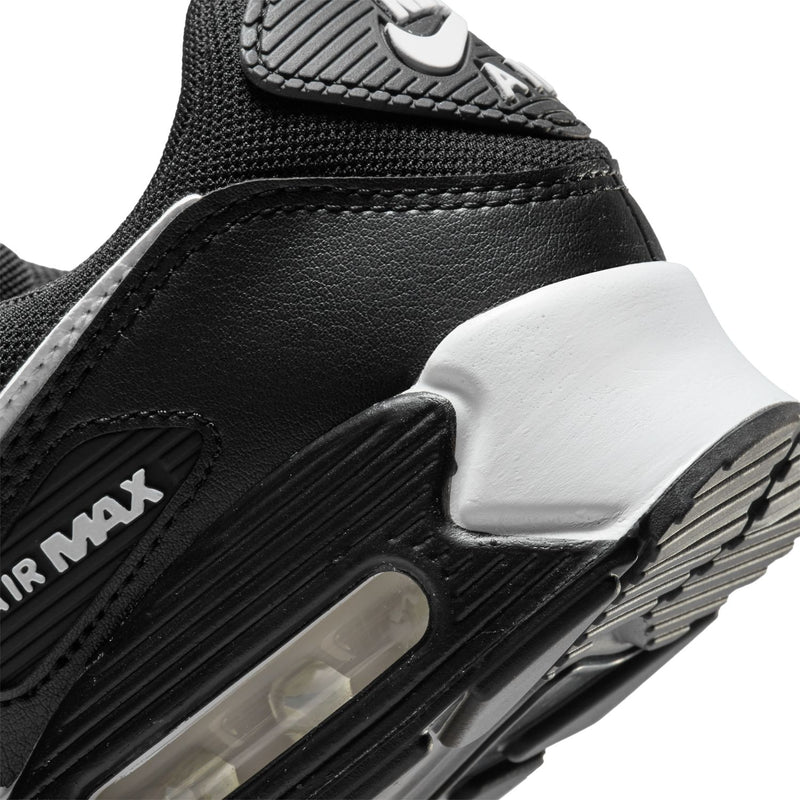 Women's Air Max 90 sneaker side view: black leather, white midsole, AIR MAX branding.