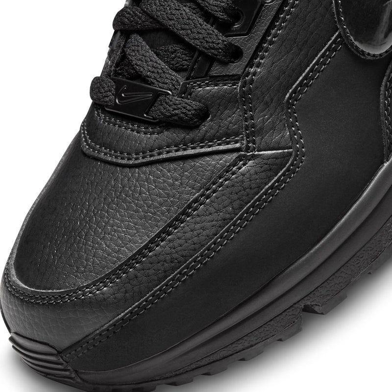 Black Air Max sneaker upper close-up with laces, eyelets, and stitched texture.