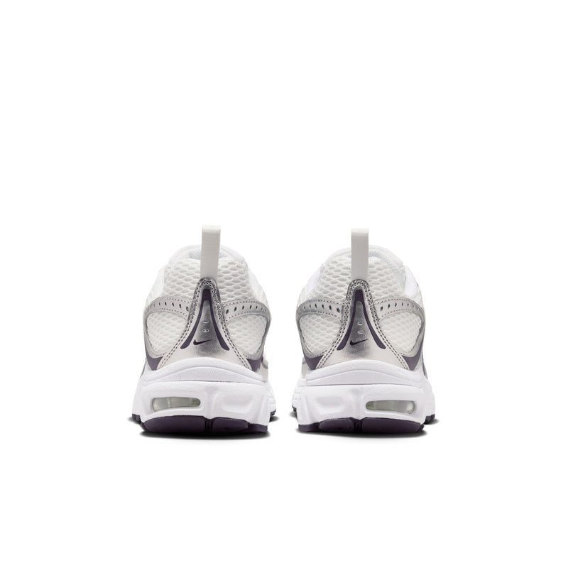 Youth white sneakers from the heel with rear NIKE branding and purple-tinted cushioning tabs
