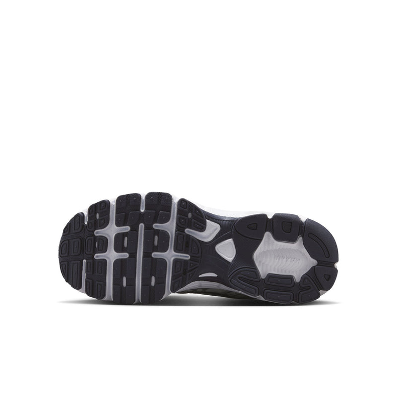 Youth sneakers outsole view with dark tread and visible cushioning pods