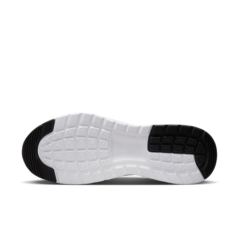 Outsole view: black tread with white midsole on Nike women's sneakers