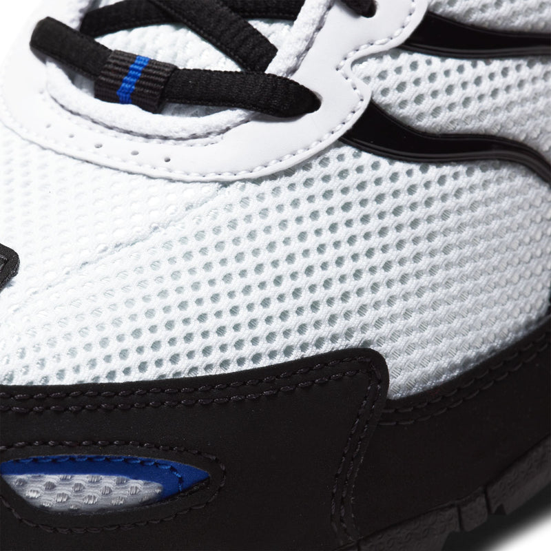 Men's running shoe close-up, white mesh texture with black laces and blue trim