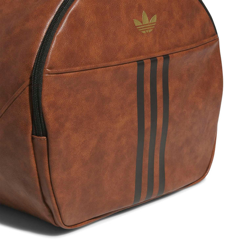Brown duffel bag side panel with vertical three-stripe detail and zipper seam